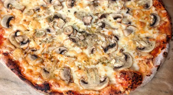 Pyszna pizza z pieczarkami i ciągnącym serem. Idealny przepis na domową pizzę, który zachwyci każdego.
